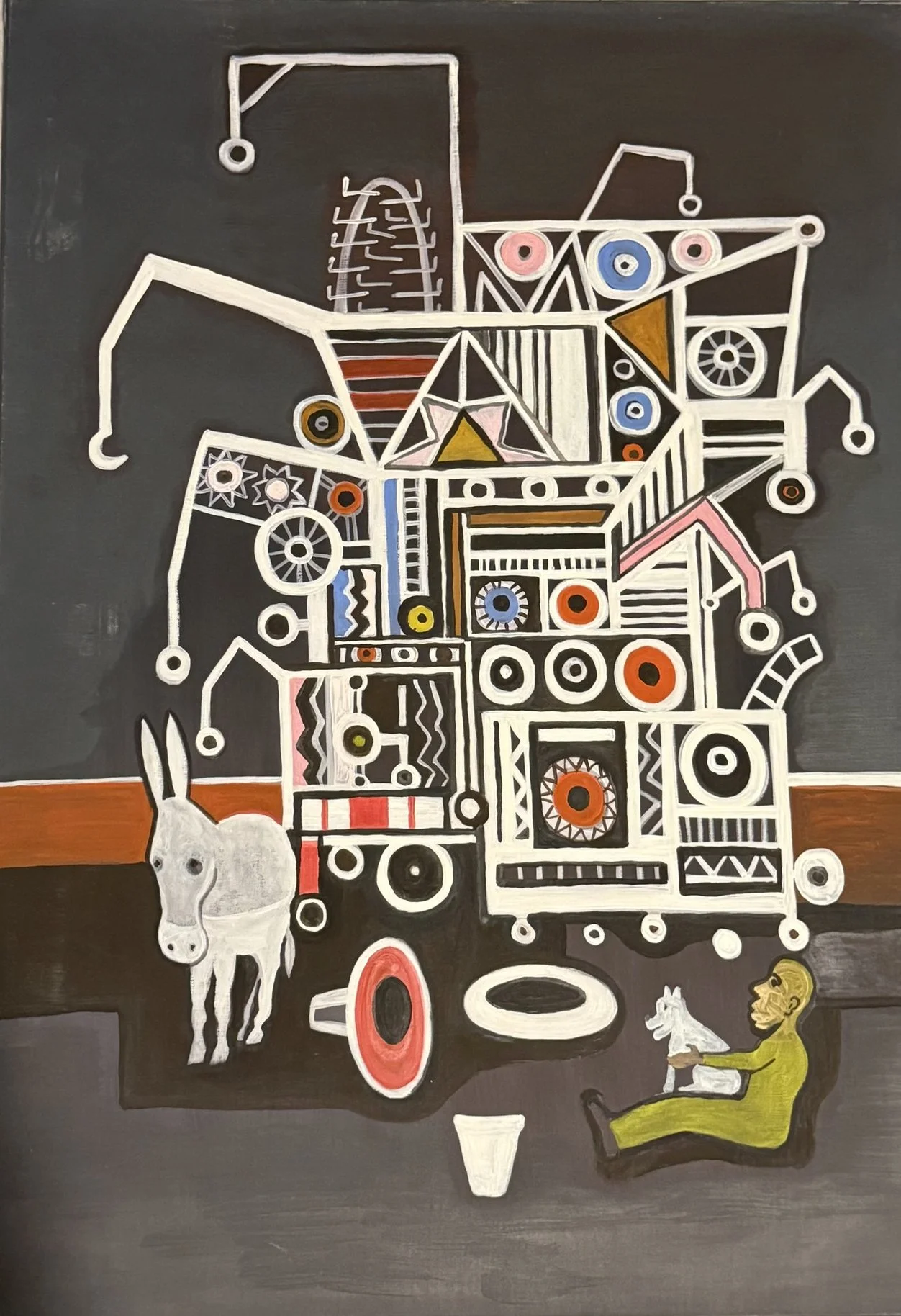 Assemblage mécanique blanc et gris, engrenages et cadrans, âne pâle et homme assis avec un chien